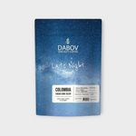 Coffee Community Colombia Late Night Decaf coffee bag with blue starry sky design and tasting notes of brown sugar